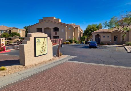 The gated entrance and covered carports