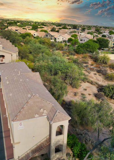 Sunset over the desert wash behind the community